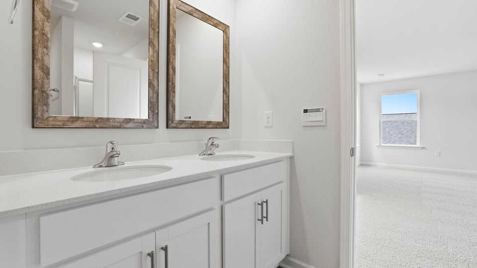 Primary bathroom with double vanity sinks.