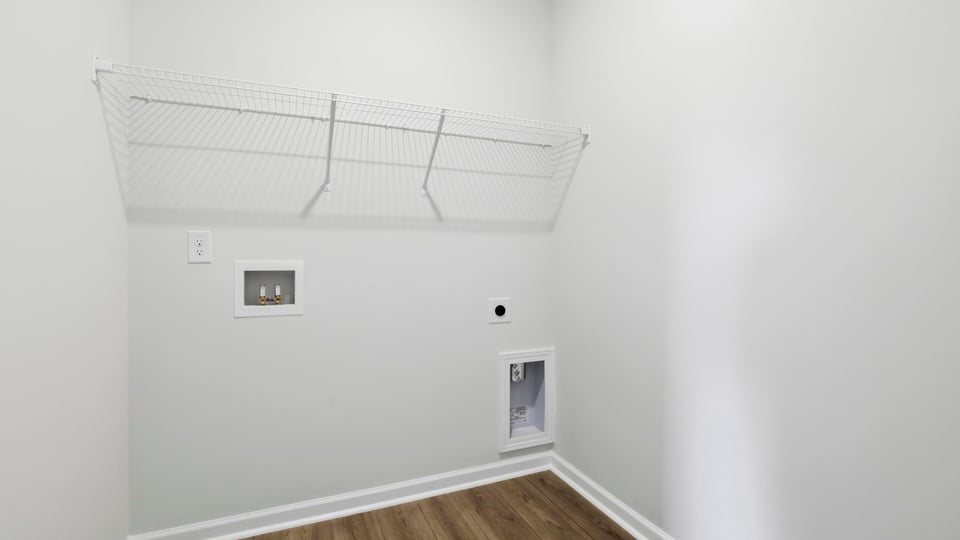 Laundry room with shelf.