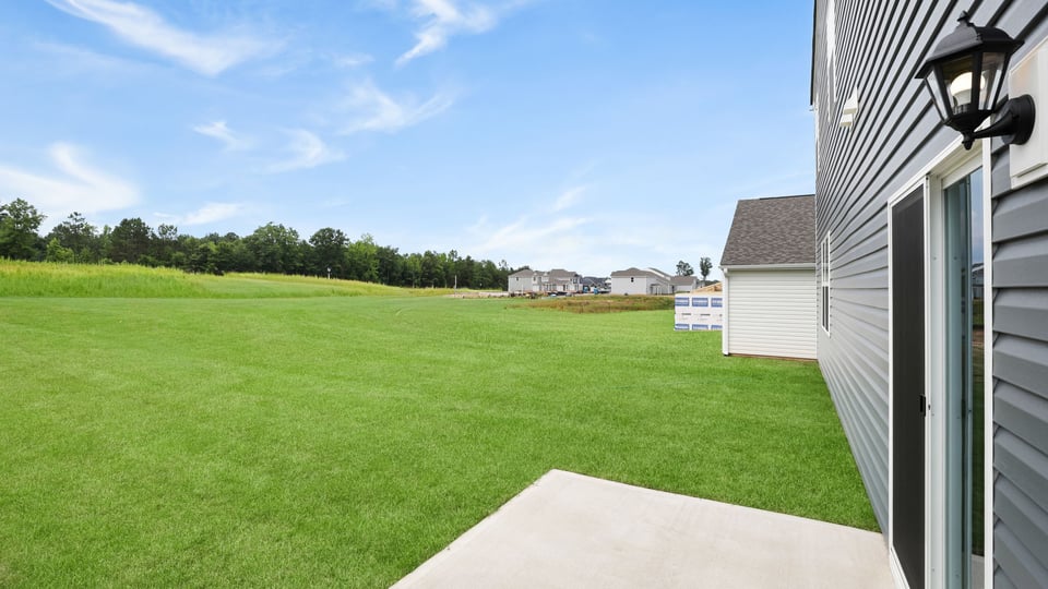 Back exterior with large backyard.