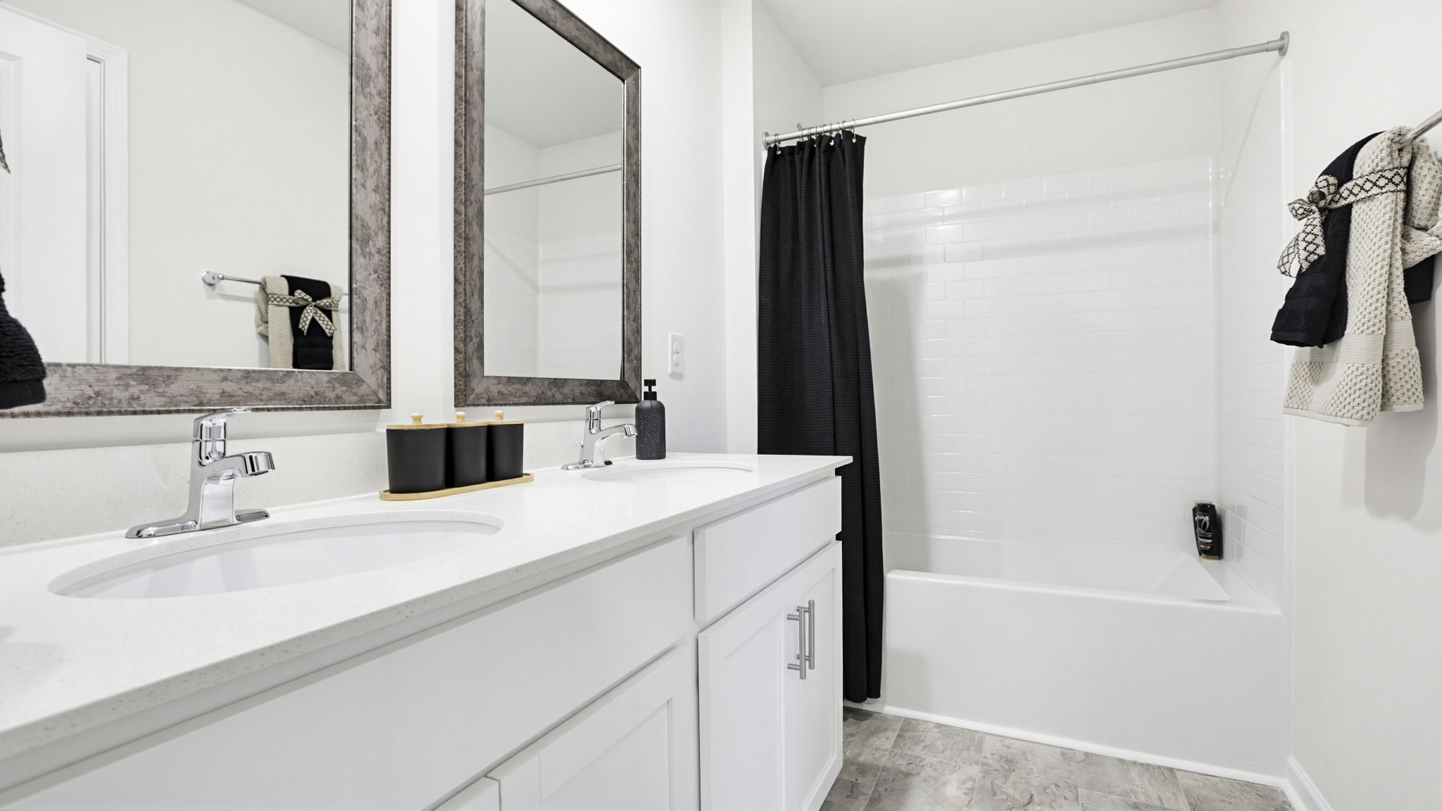Bathroom with double vanity sink and walk in shower.