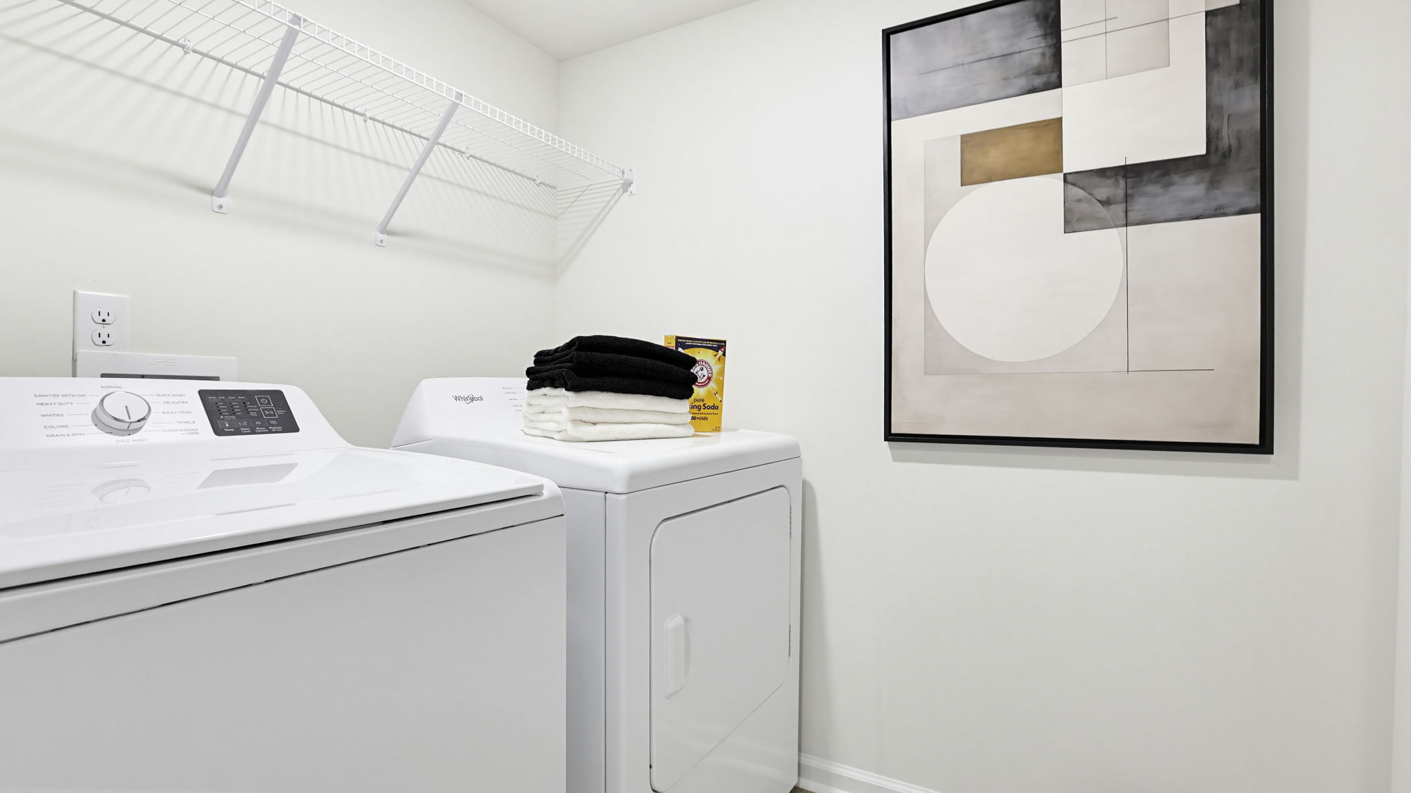 Laundry room with hanging storage racks.