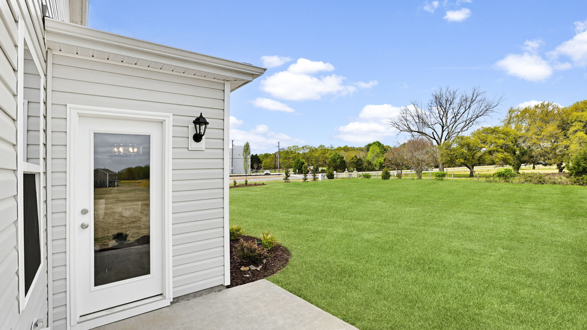 Back exterior of home with large backyard.