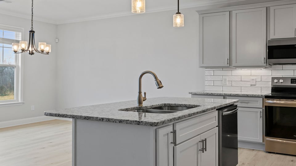 Kitchen with island and granite countertops.