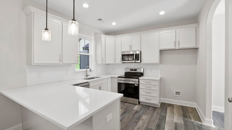Kitchen with quartz countertops and island.