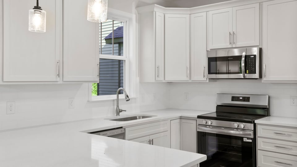 Kitchen with quartz countertops and island.