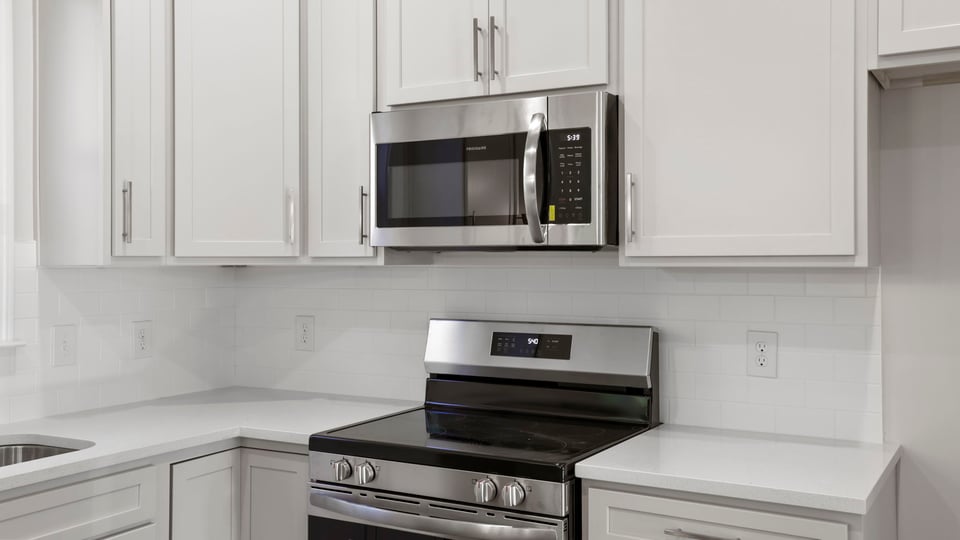 Kitchen with quartz countertops and island.