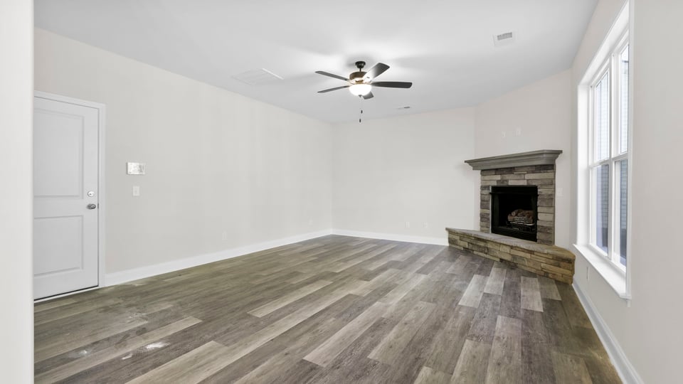 Family room with fireplace and window.