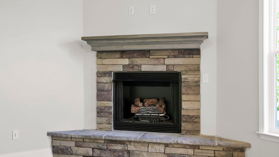 Family room with fireplace and window.