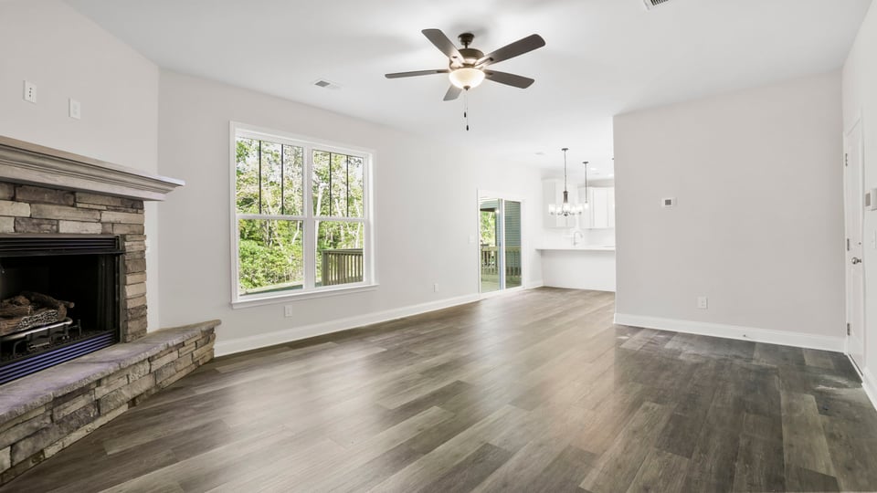 Family room with fireplace and window.