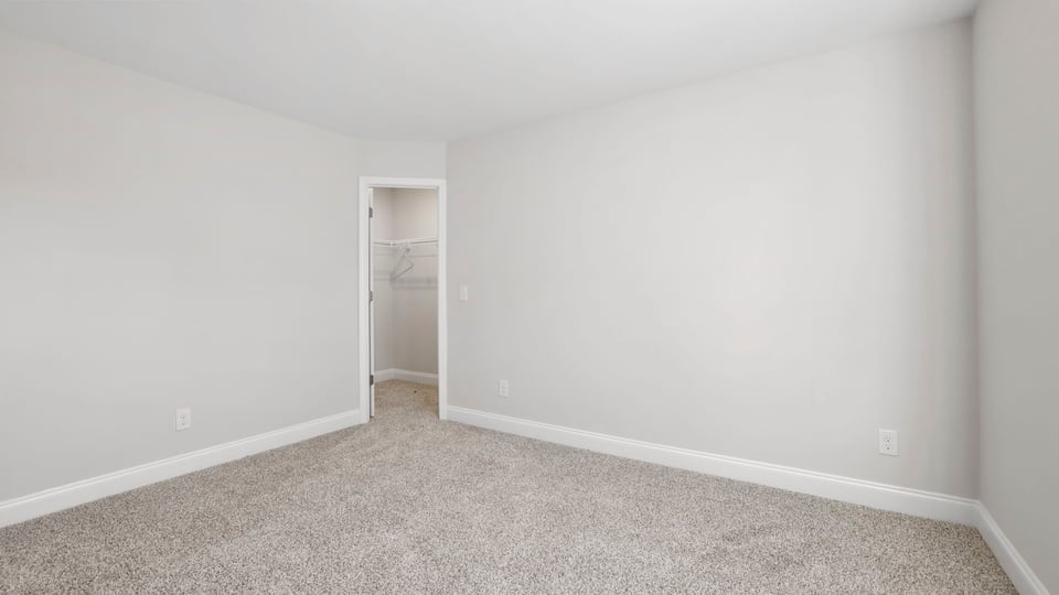 Bedroom with carpet and window.