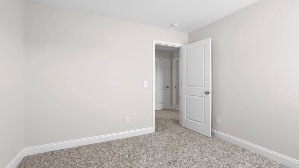 Bedroom with carpet and window.