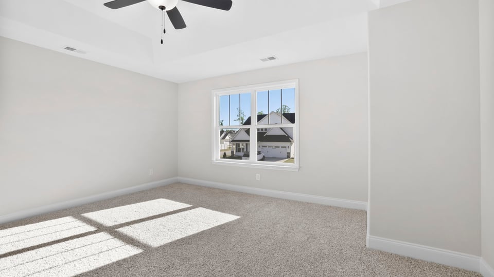Bedroom with carpet and window.