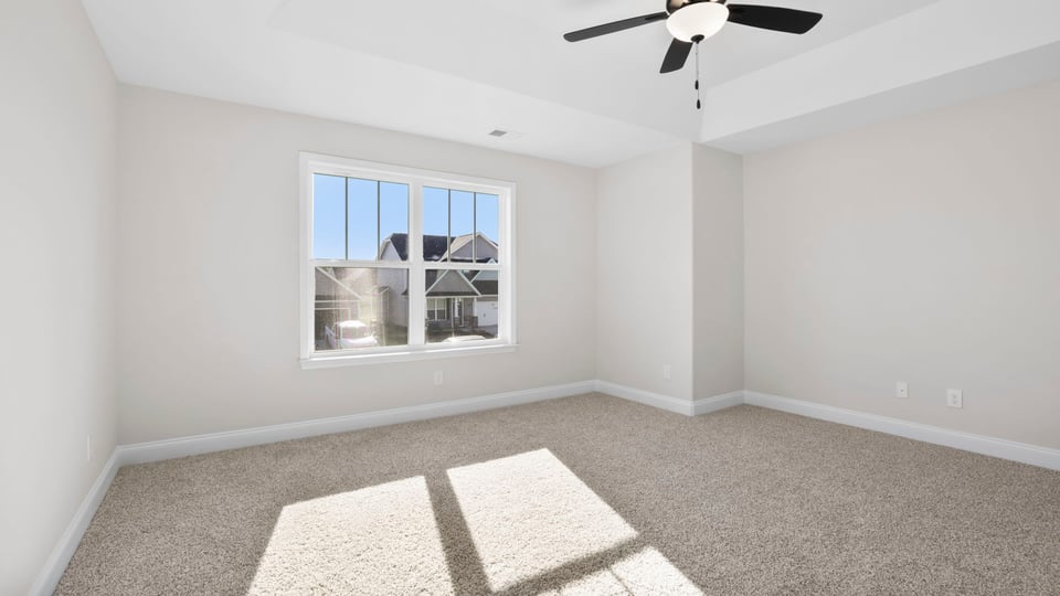 Bedroom with carpet and window.