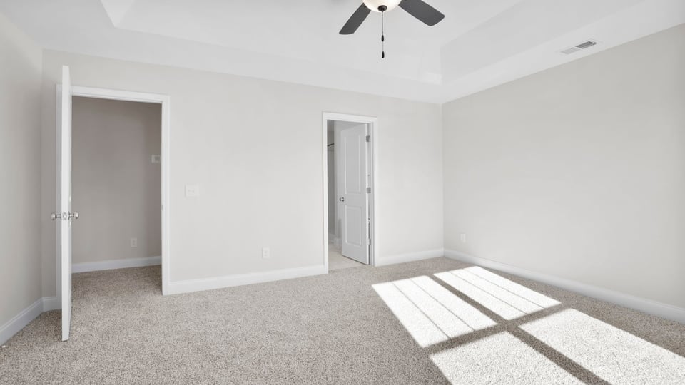Bedroom with carpet and window.