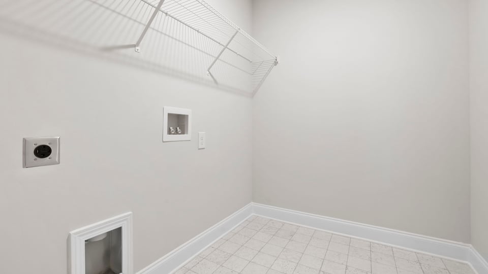 Laundry room with hanging storage racks.