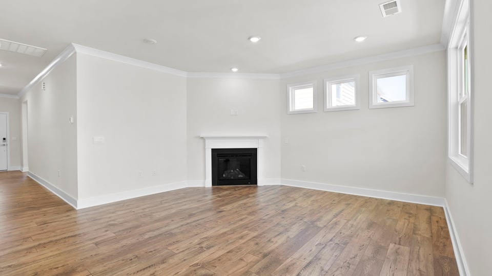 Living area with fireplace and windows.