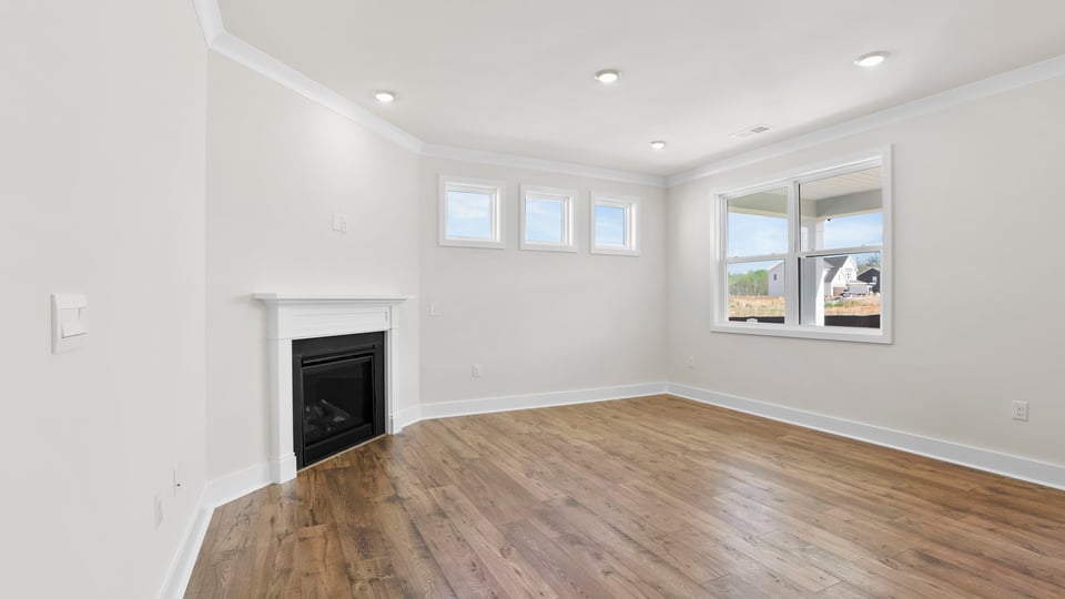 Living area with fireplace and windows.