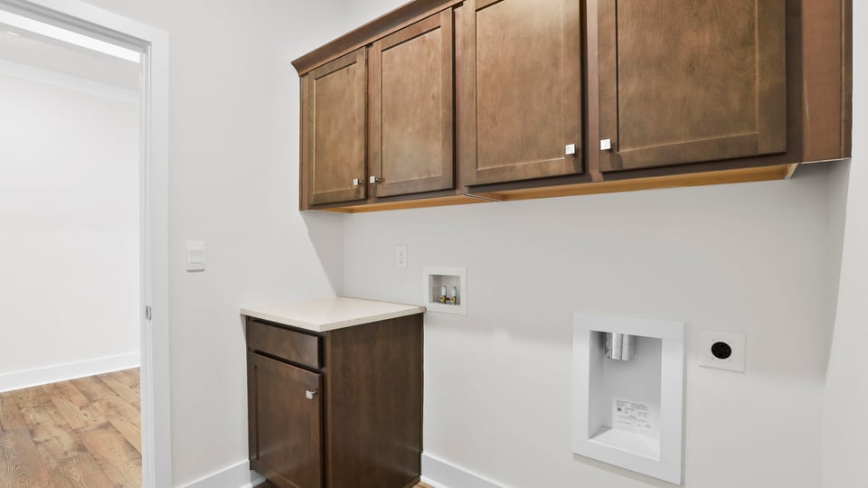 Laundry room with cabinets.