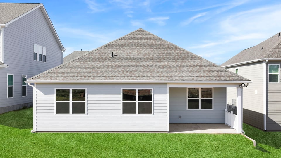 Back exterior with covered patio.