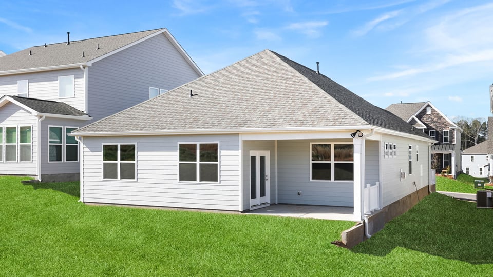 Back exterior with covered patio.