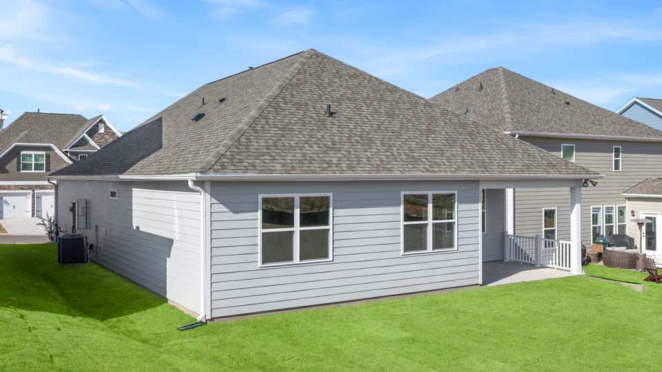 Back exterior with covered patio.