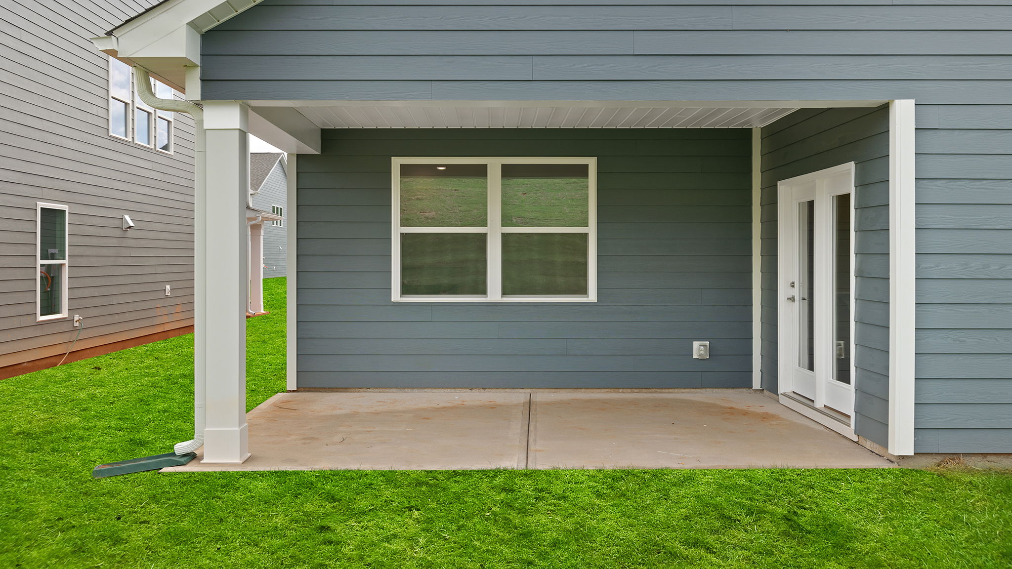 Back covered patio with large backyard.