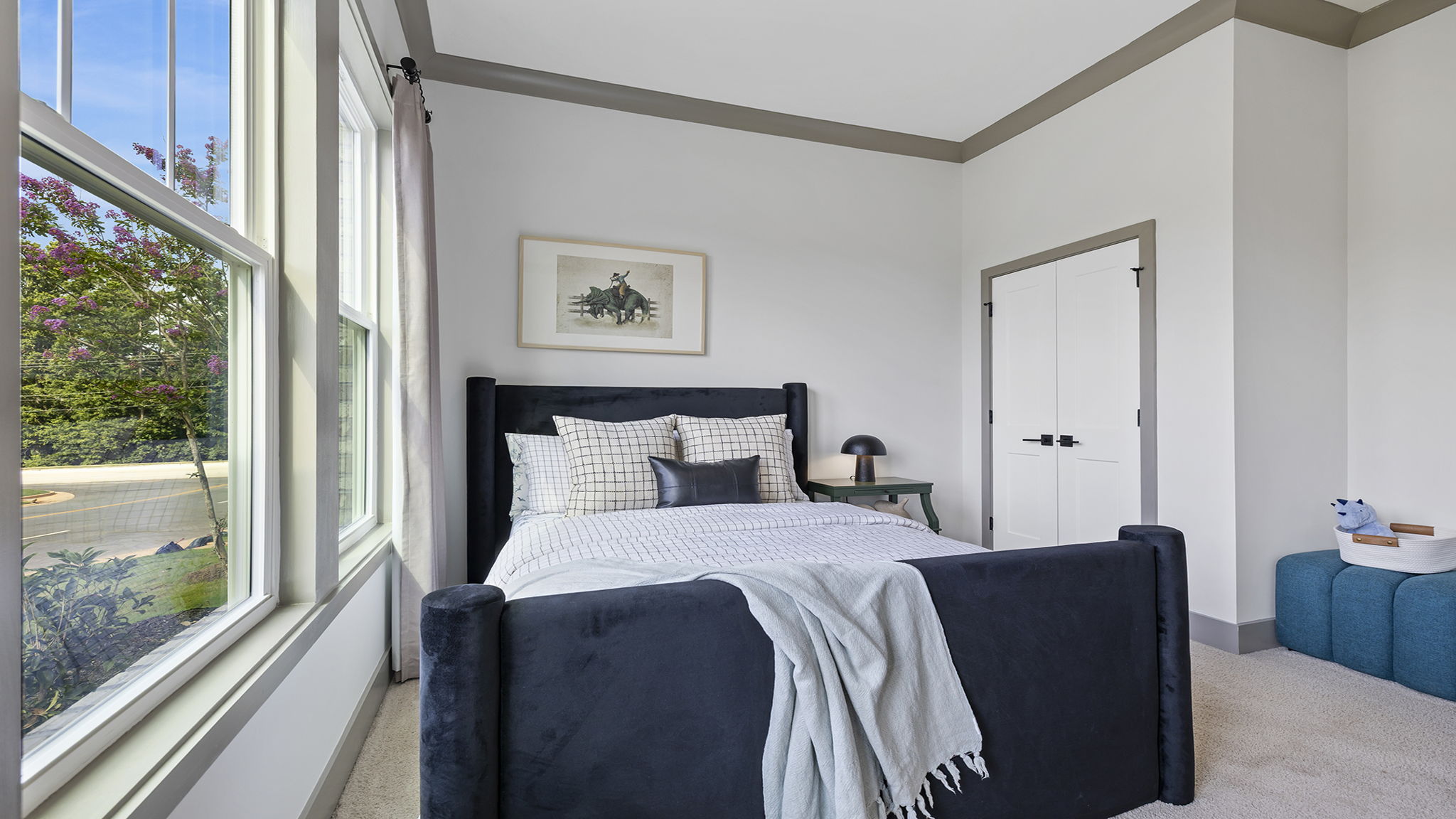 Bedroom with carpet and windows.
