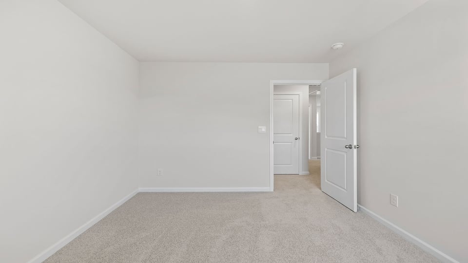 Bedroom with carpet and windows.