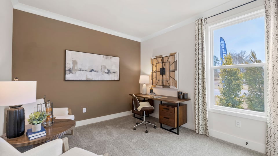 Bedroom with carpet and windows.