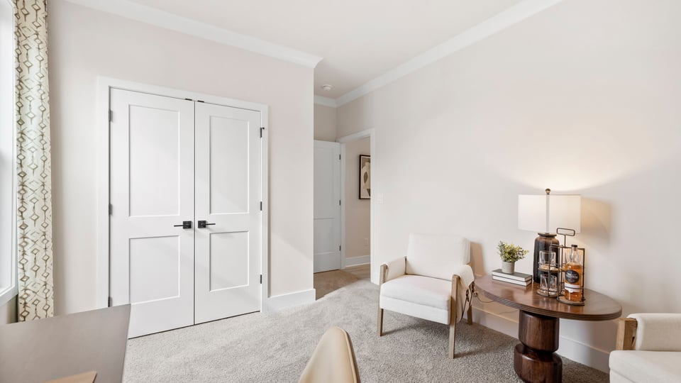 Bedroom with carpet and windows.