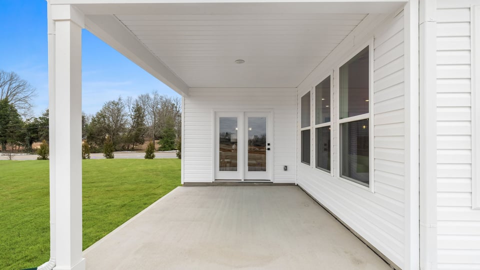 Back covered patio with large backyard.