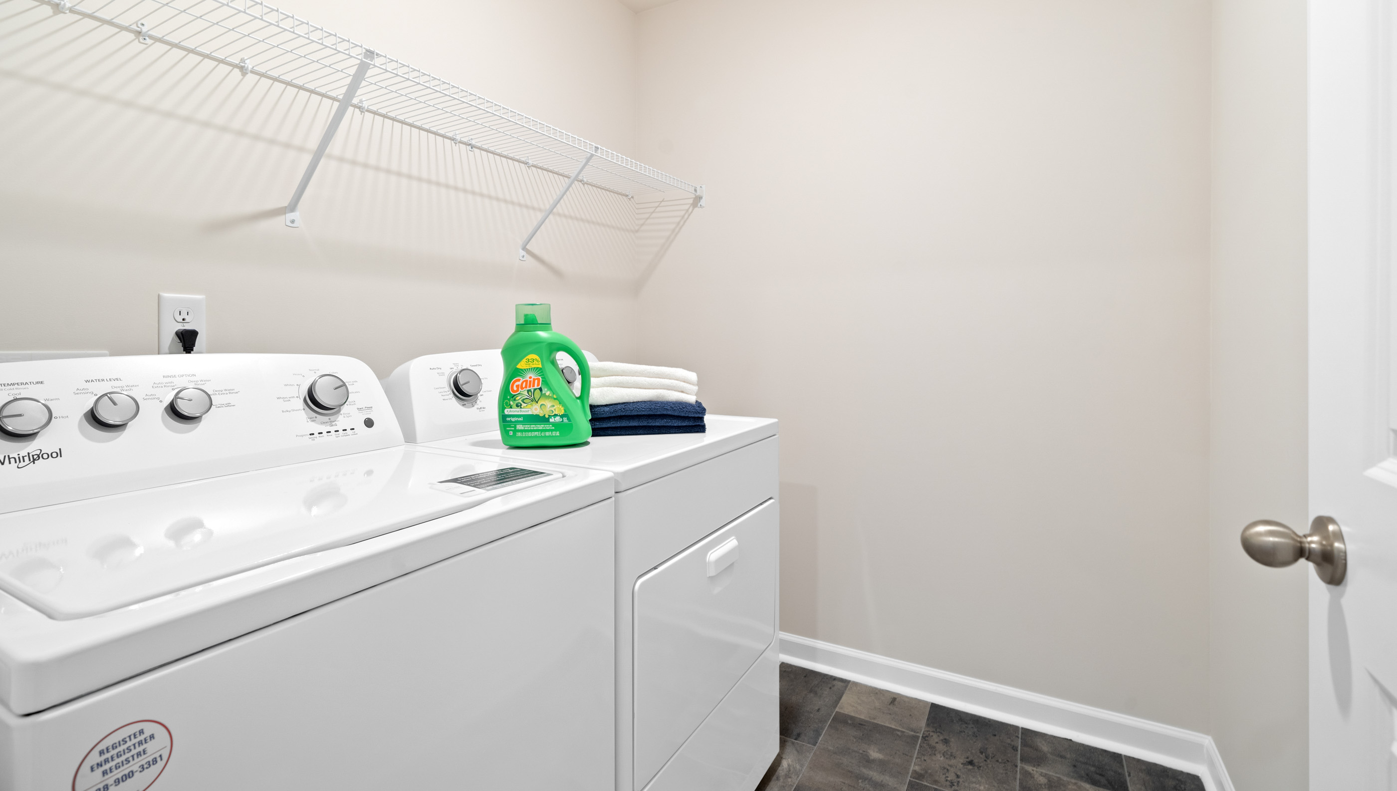 Laundry room with shelf.