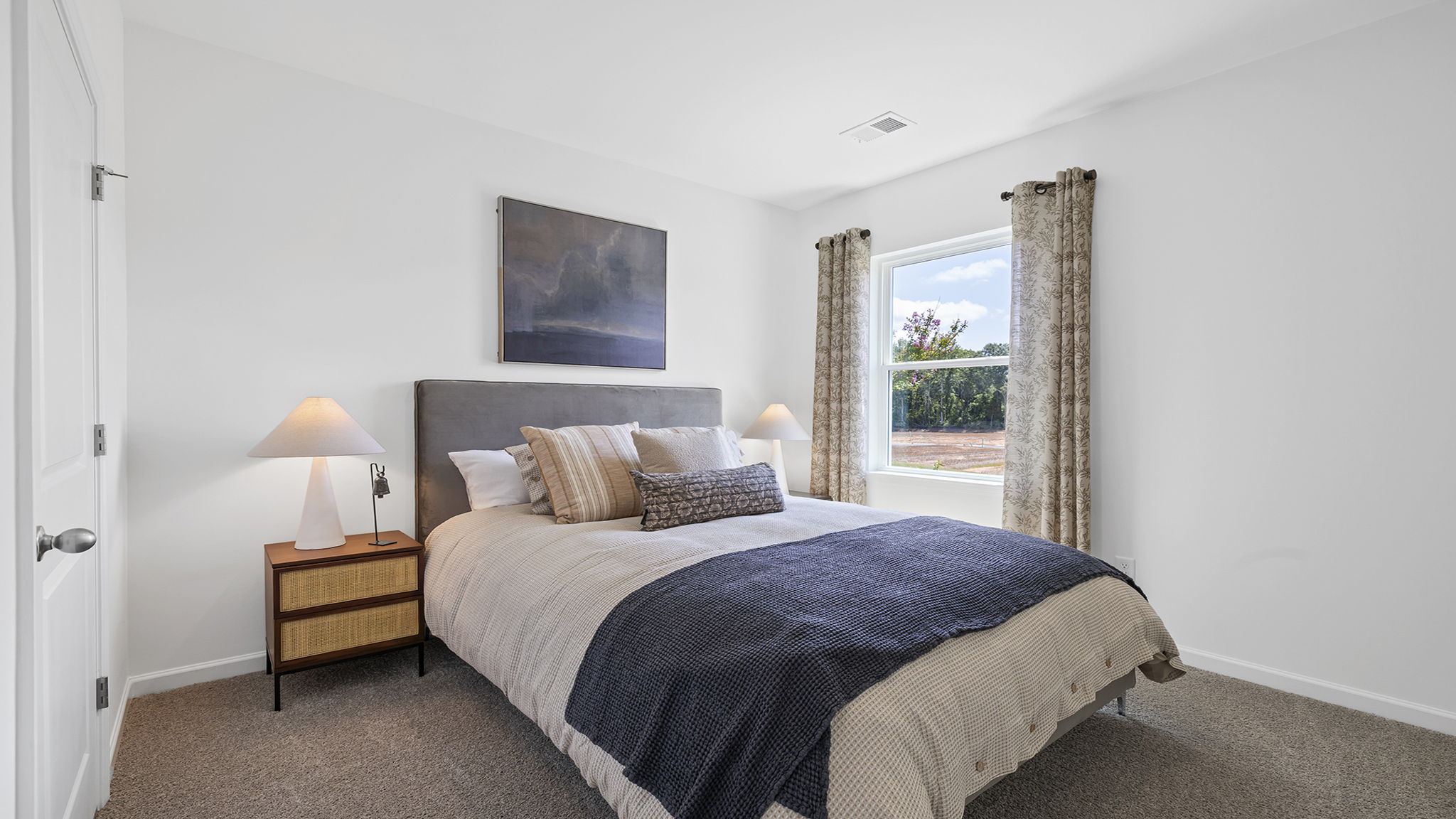 Bedroom with carpet and window.