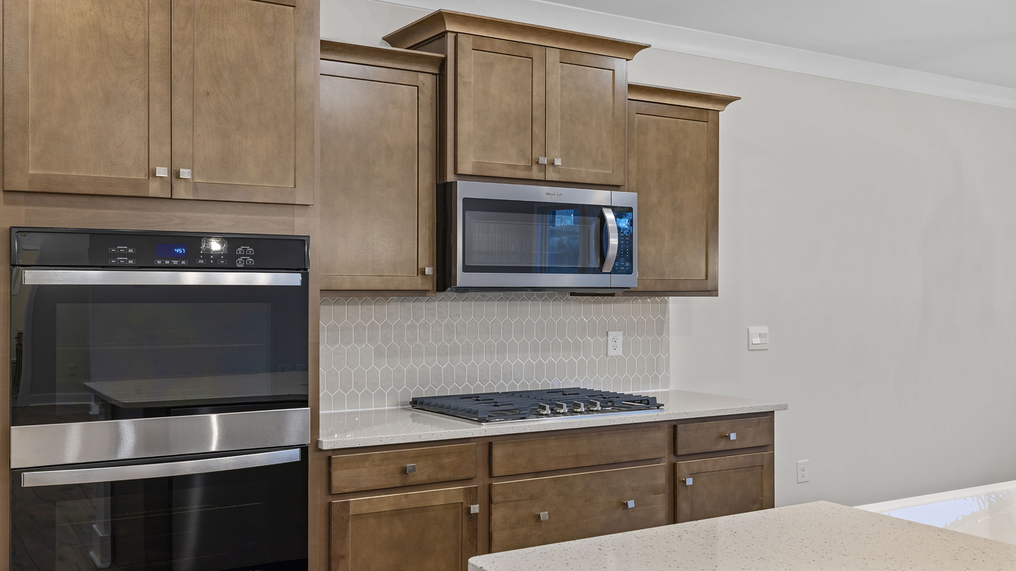 Stainless wall ovens, gas cooktop and built-in microwave.