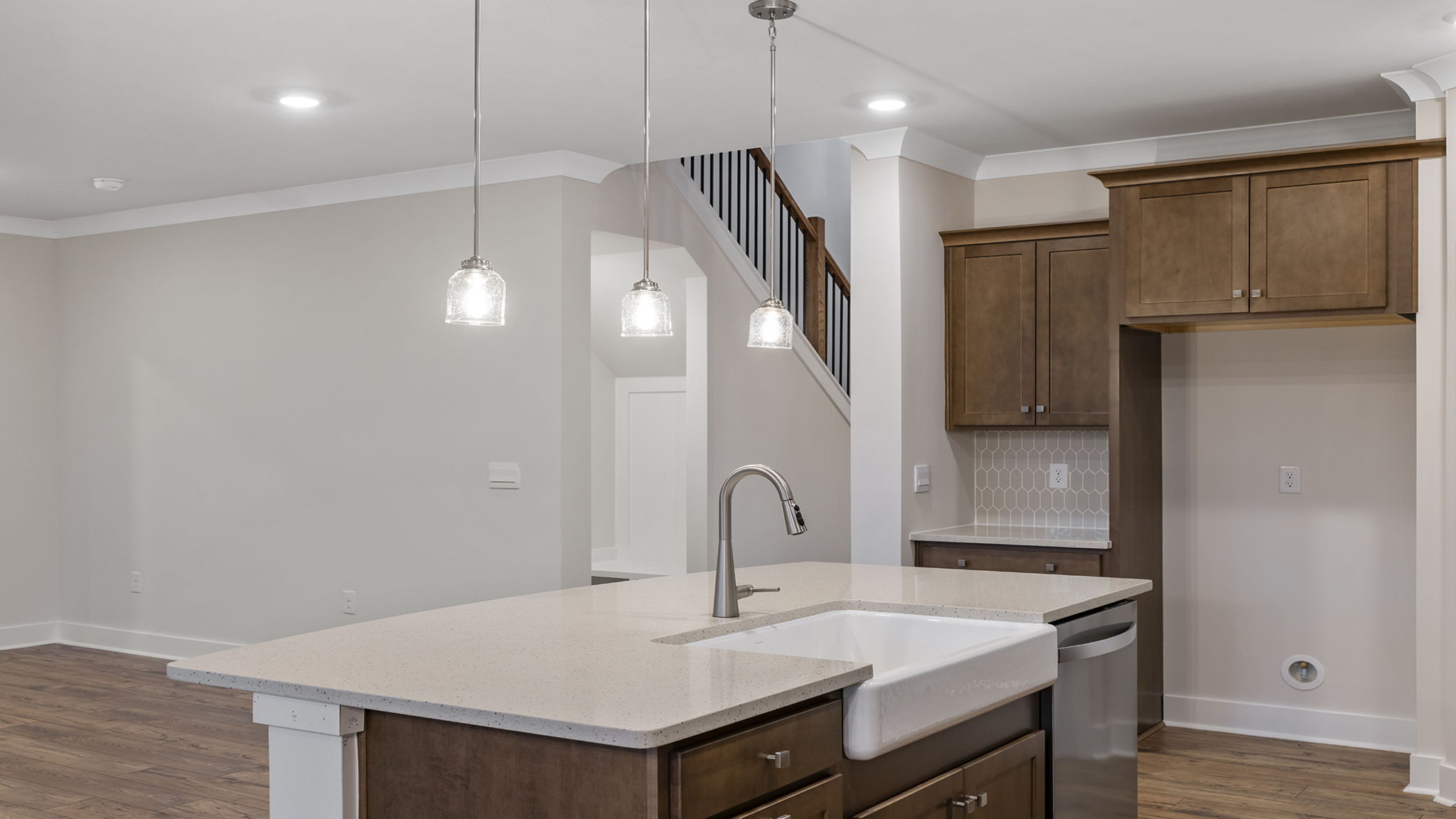Kitchen with island and quartz countertops.