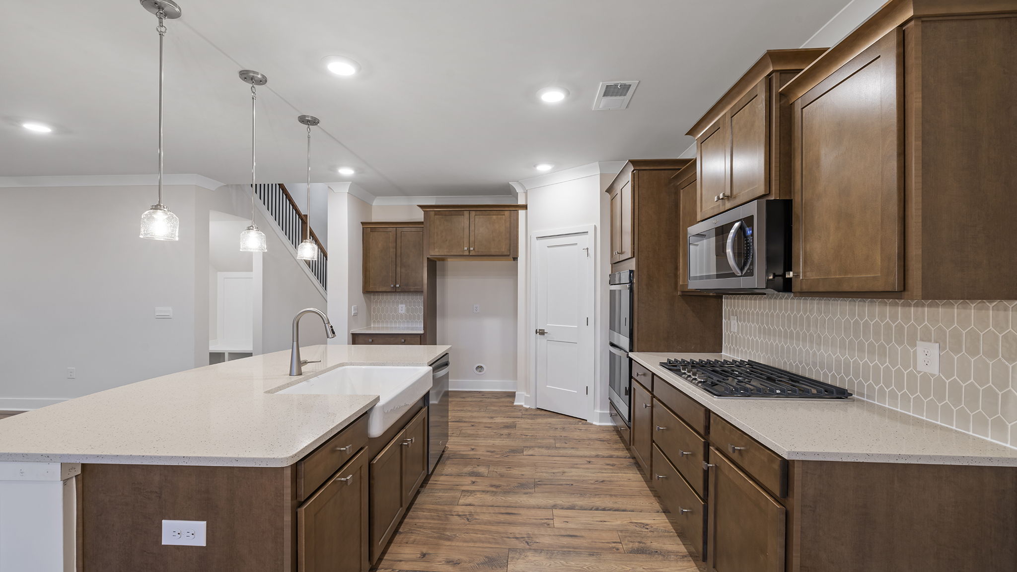 Kitchen with island and quartz countertops.