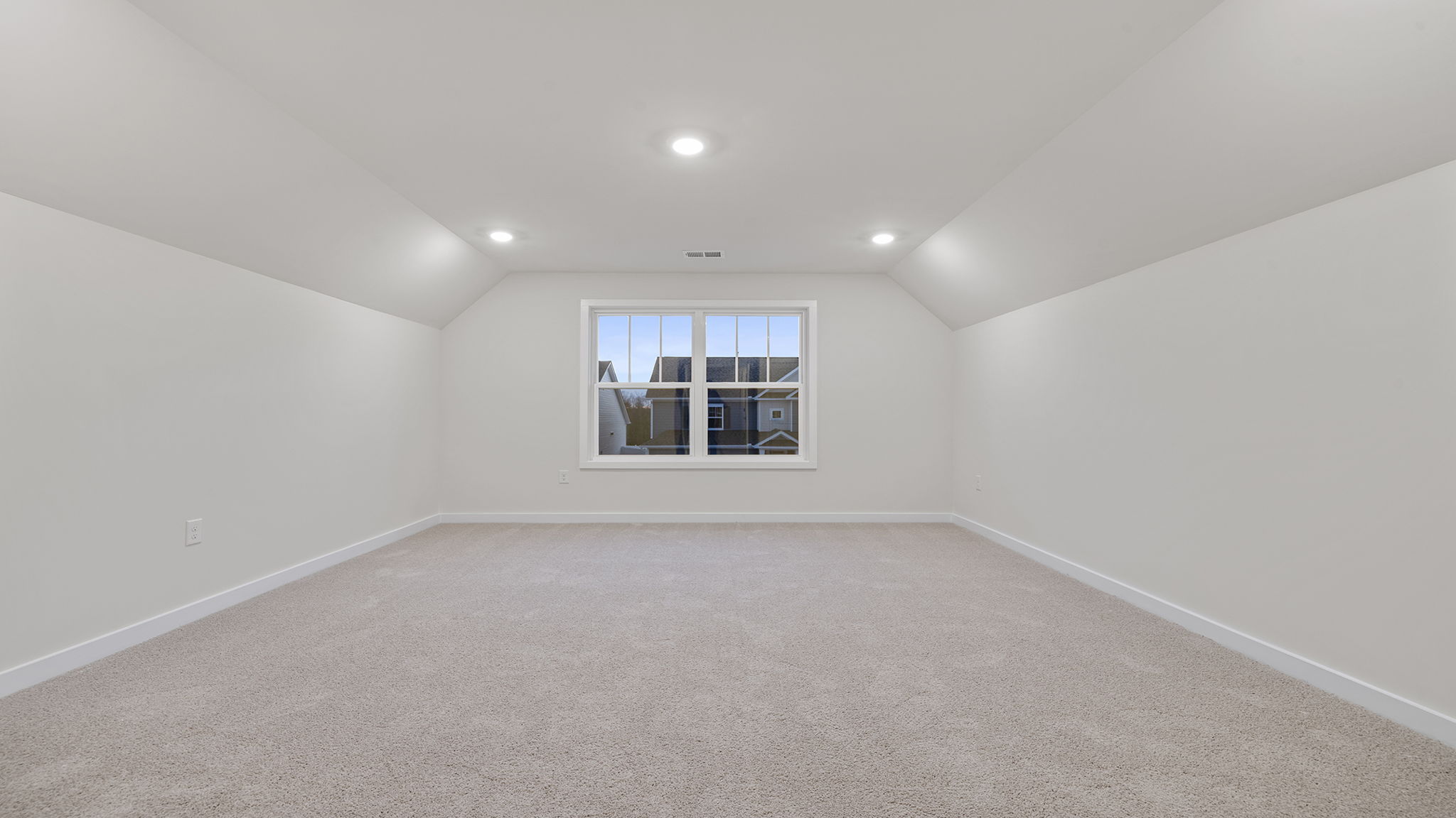 Bonus room with windows and recessed lighting.