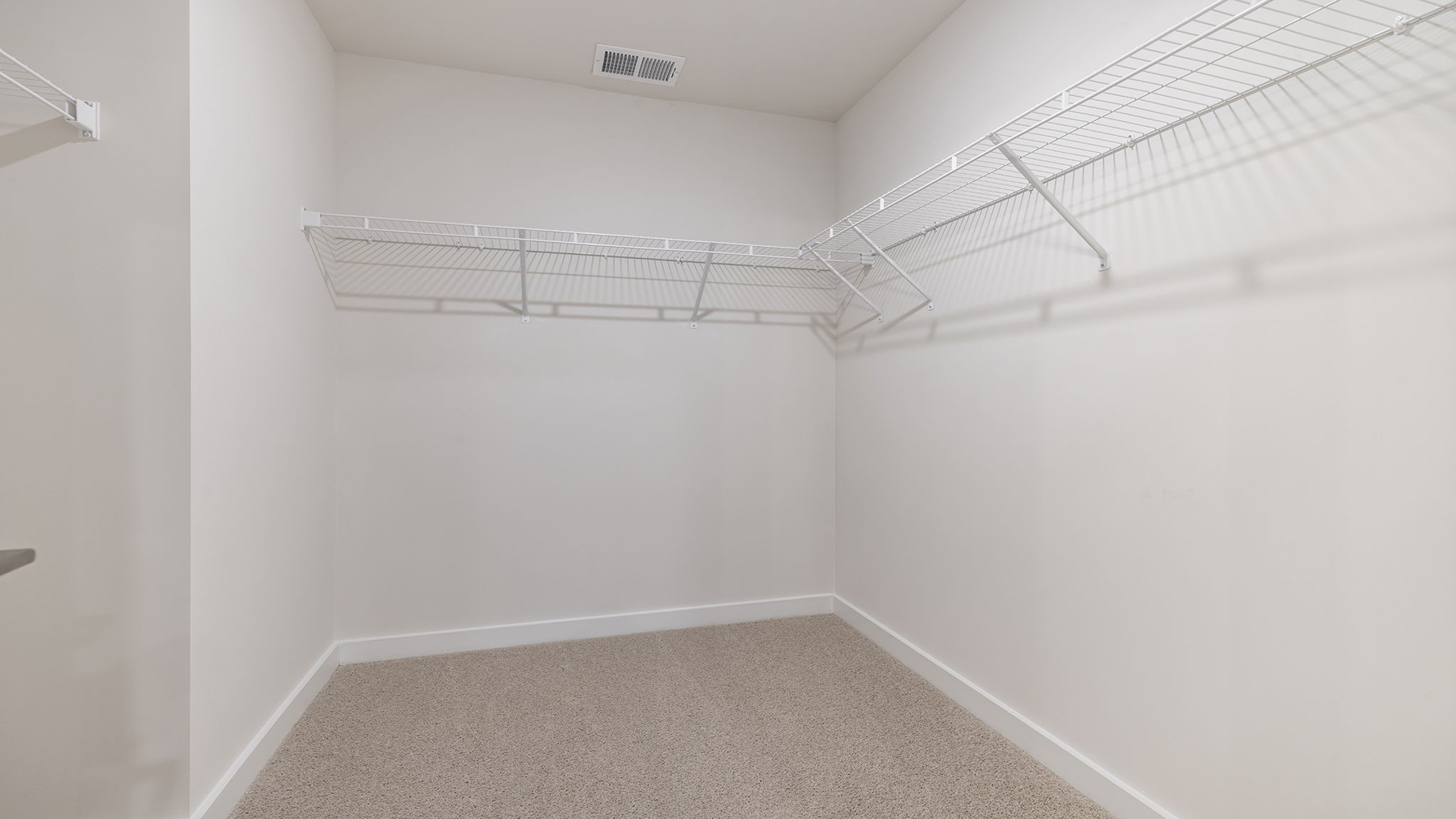 Primary bedroom walk-in closet.
