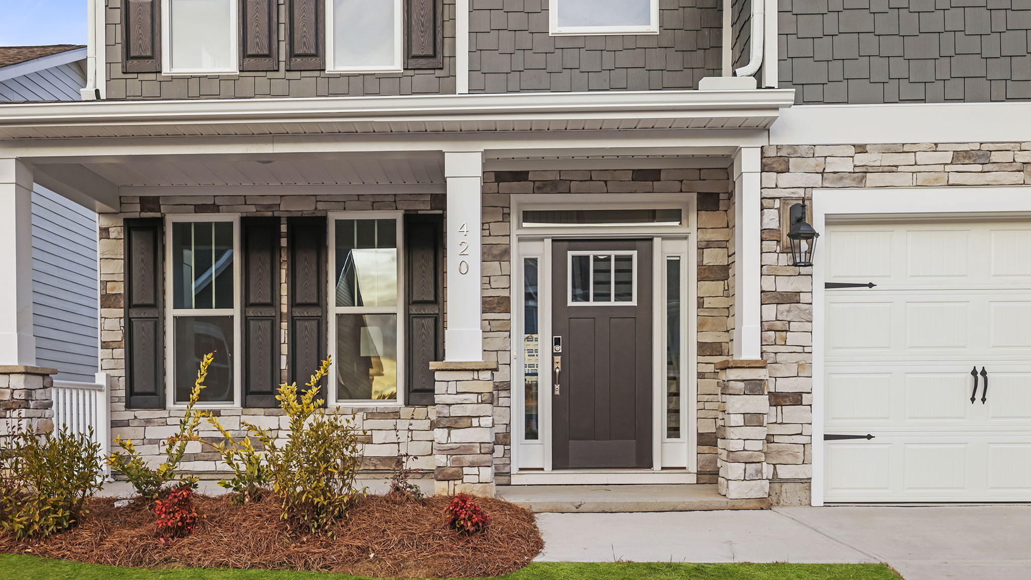 Inviting front porch with stone accents.