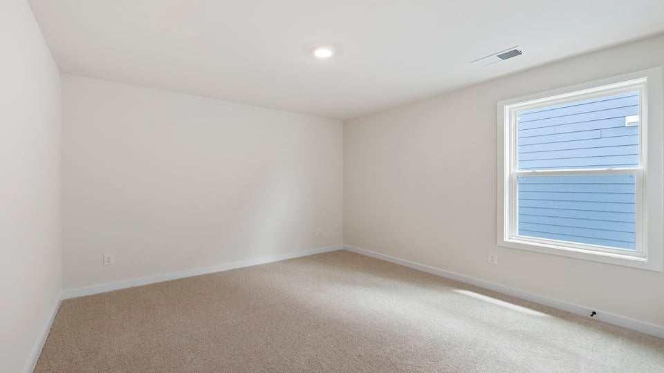 Bedroom with carpet and window.