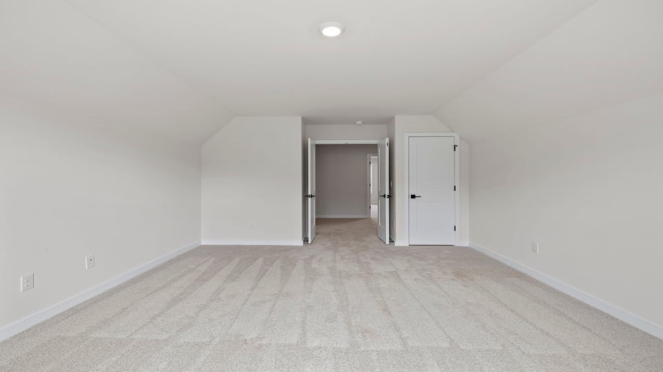 Loft area with window and carpet.