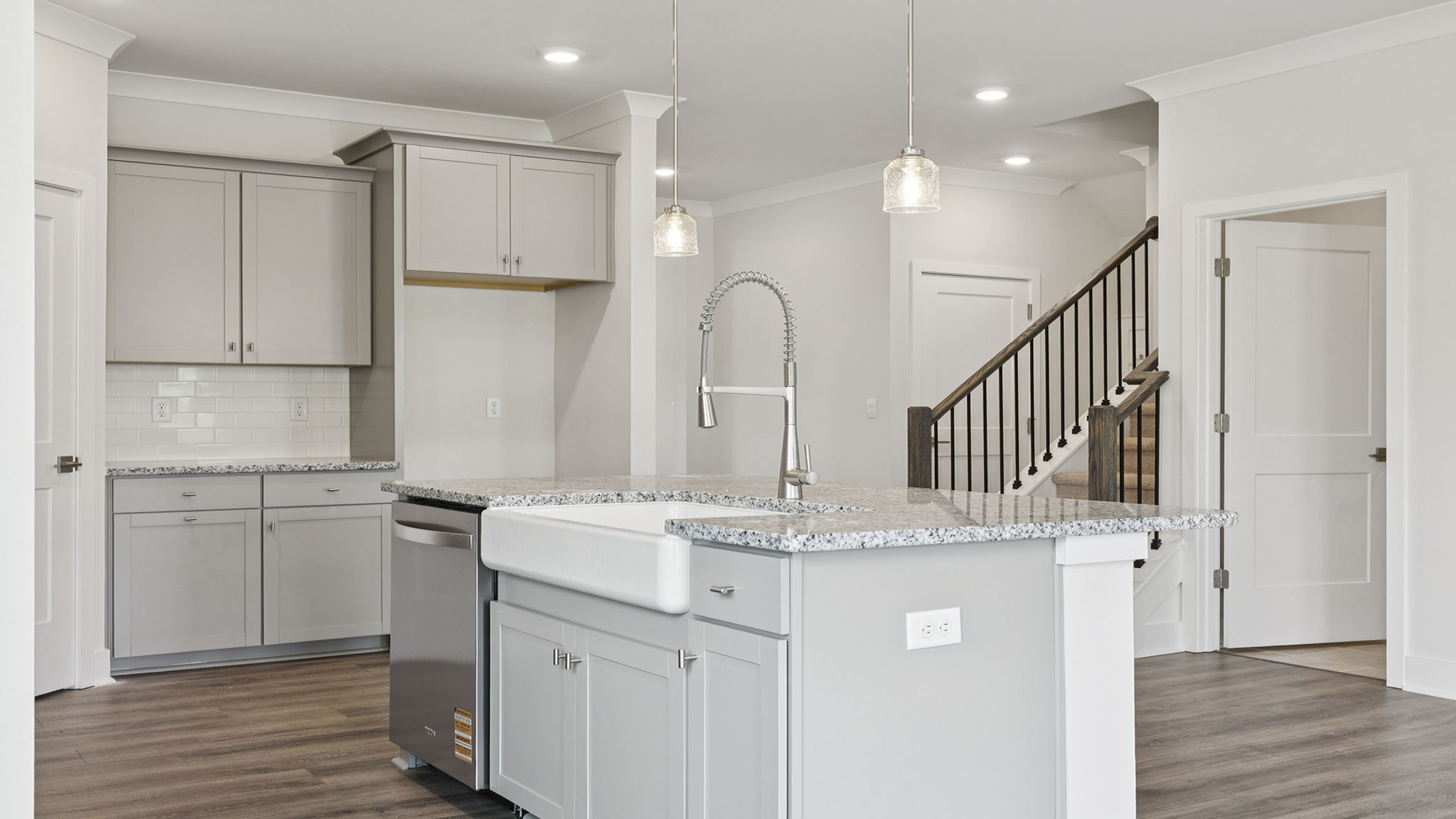 Kitchen island hosts the sink and dishwasher.