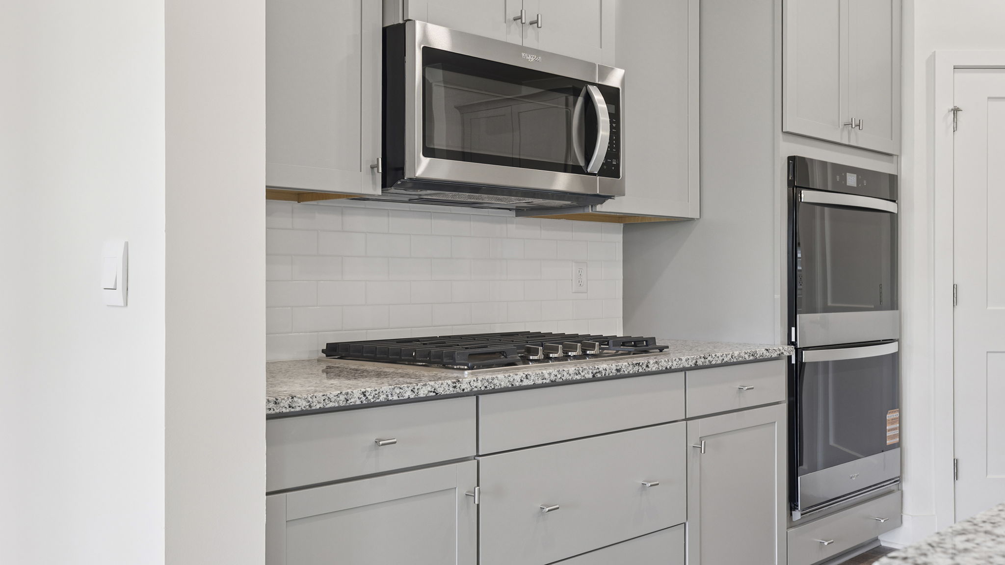 Stainless steel wall ovens, gas stove top and built-in microwave.