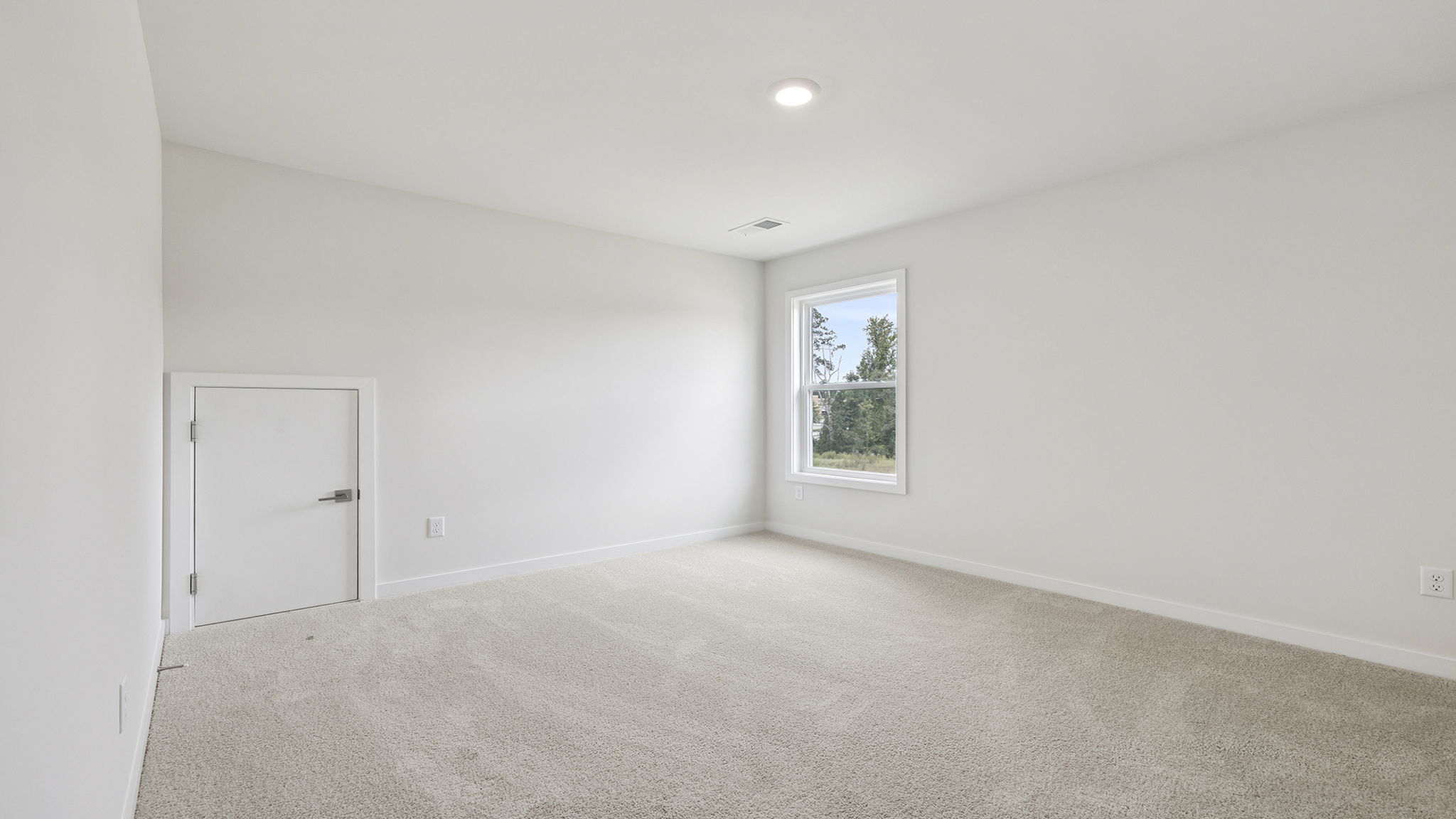Bedroom with carpet and window.