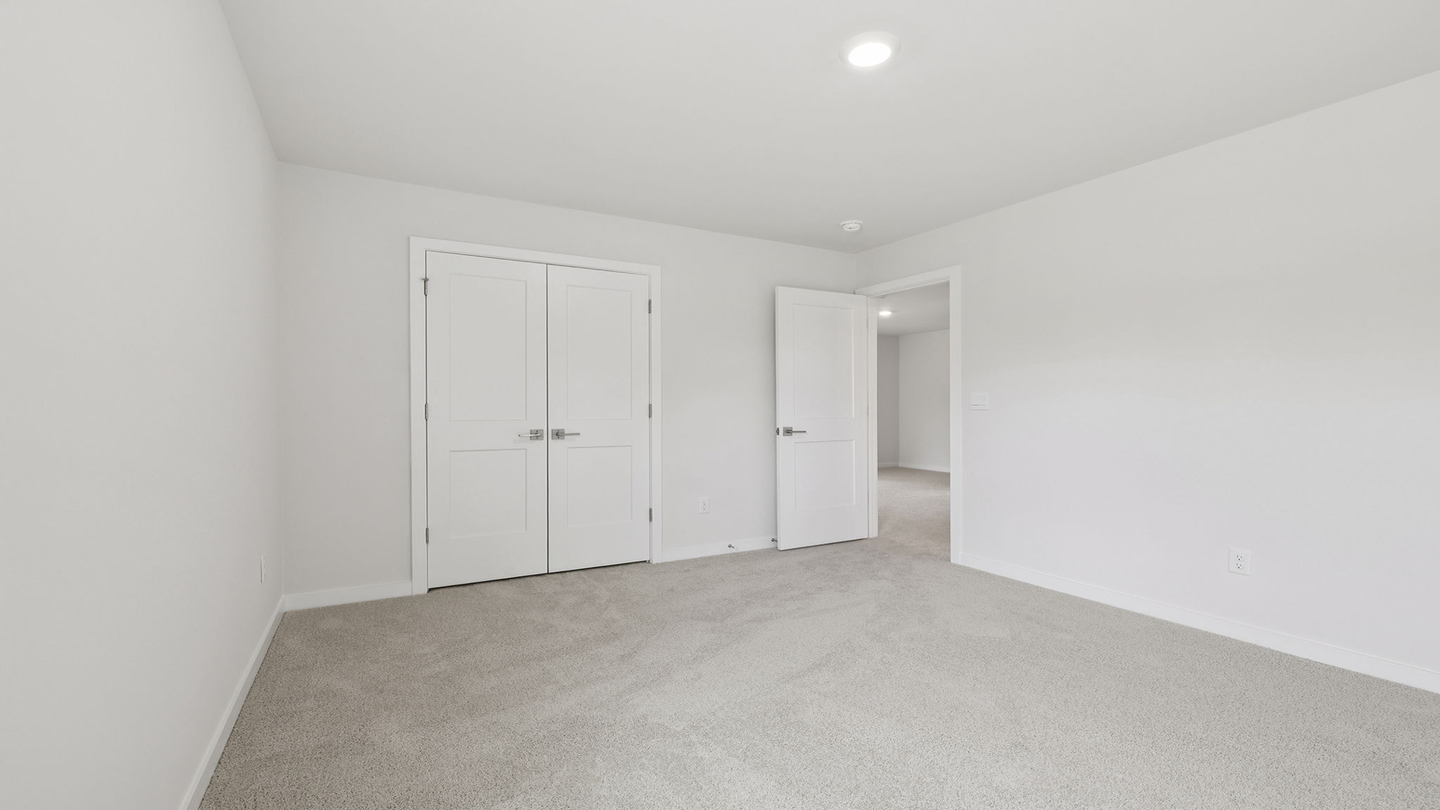Bedroom with carpet and window.