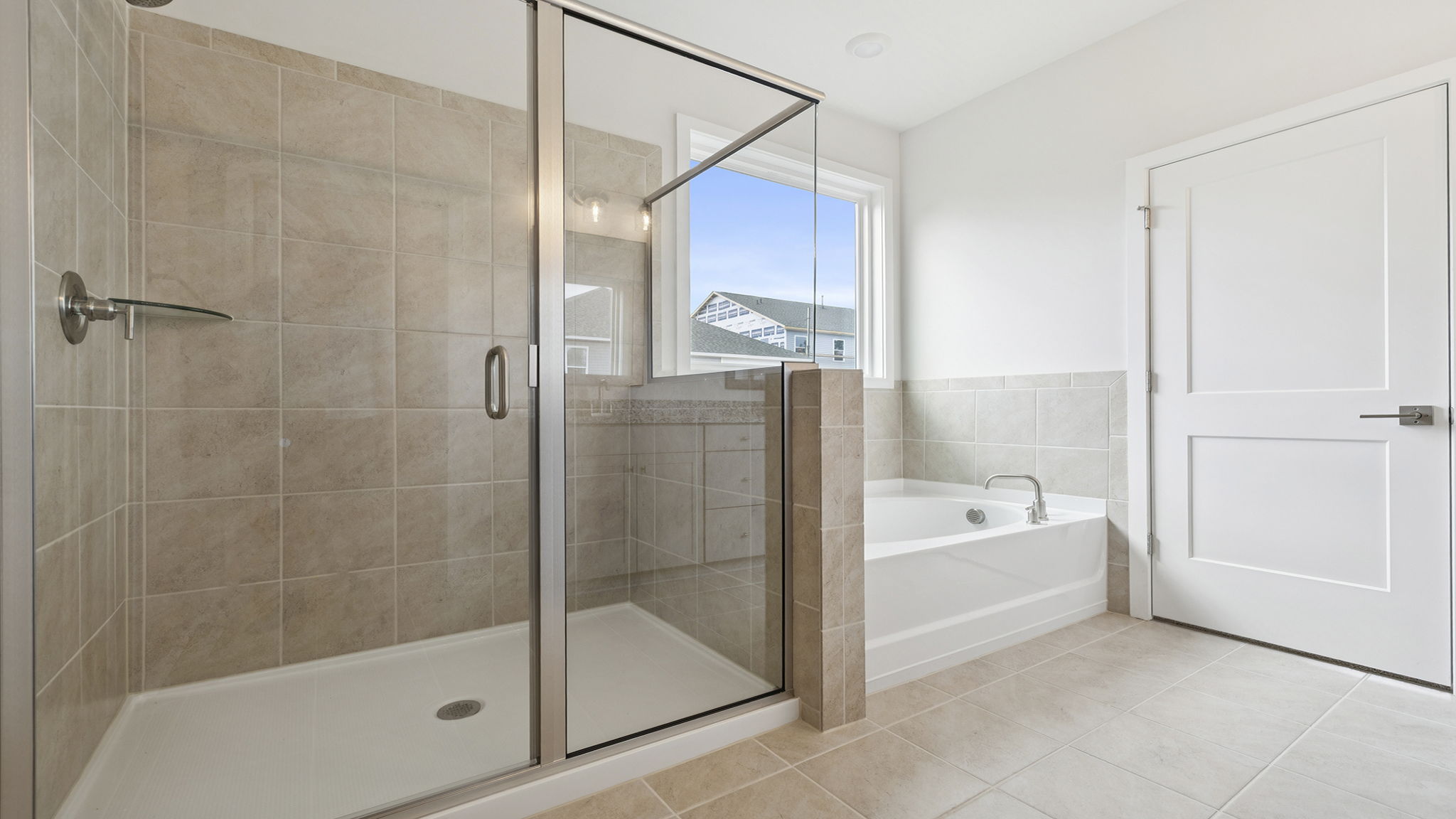Primary bathroom with walk-in shower and garden tub.