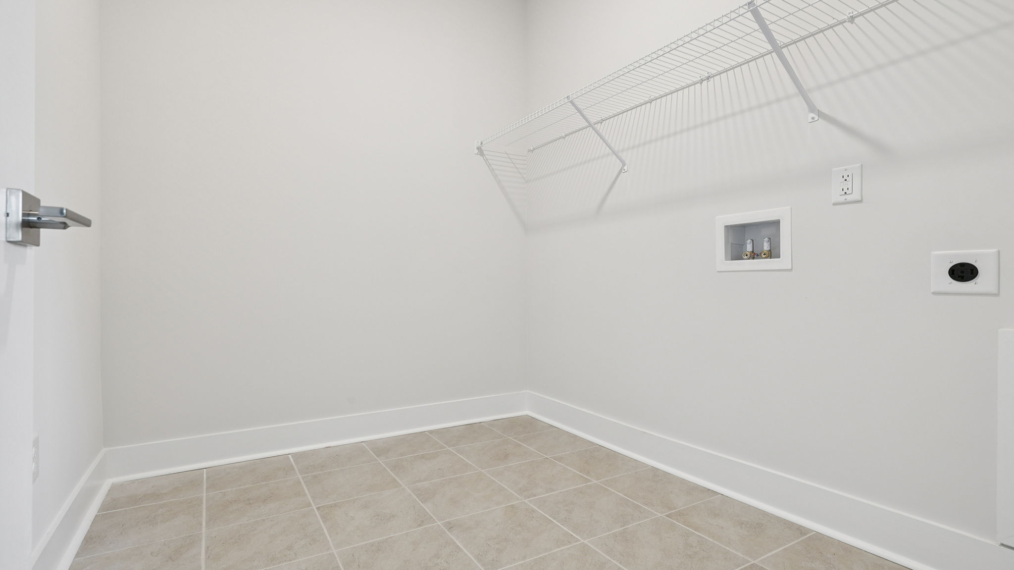 Walk-in laundry room with shelving.