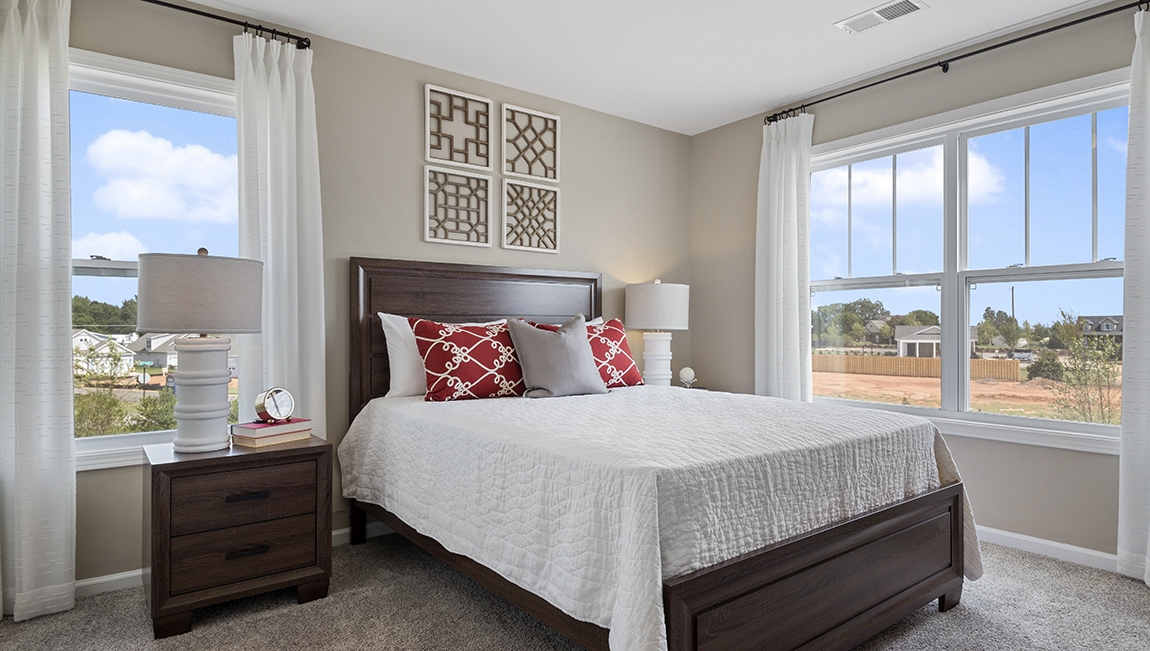 Bedroom with carpet and window.