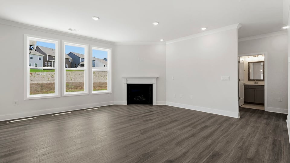 Living room with windows and fireplace.