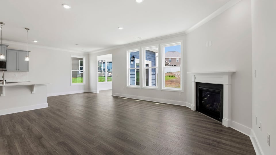 Living room with windows and fireplace.